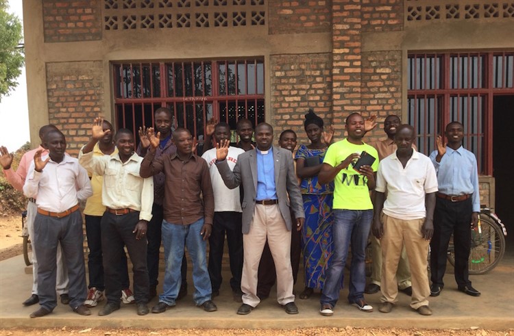 Pastor Alfred and church leaders in Gasura parish, Diocese of Gasabo, standing in front of the new school building